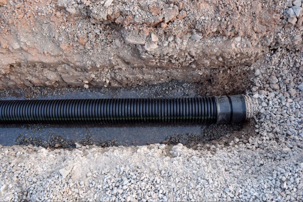 Buried Sewer Line in Road Construction Water Main Tubing Piping Water Infrastructure Plumbing.